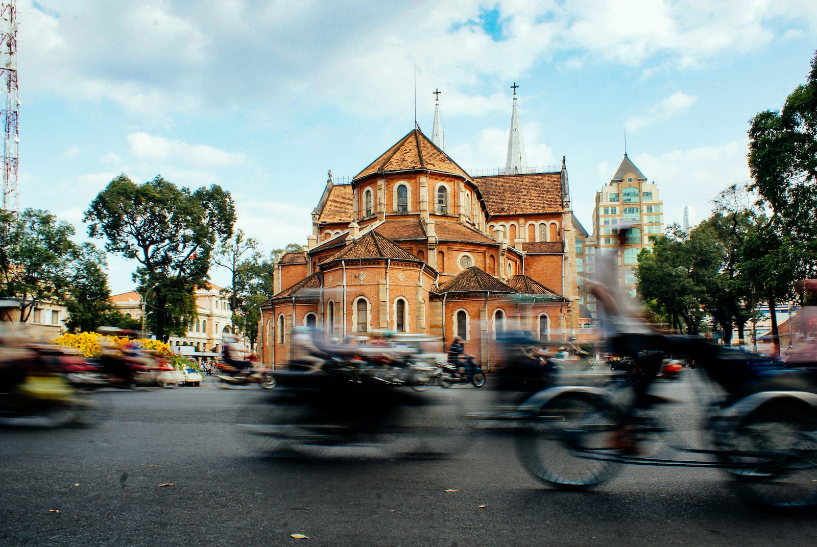 Traffic moving past Notre-Dame Cathedral in Vietnam